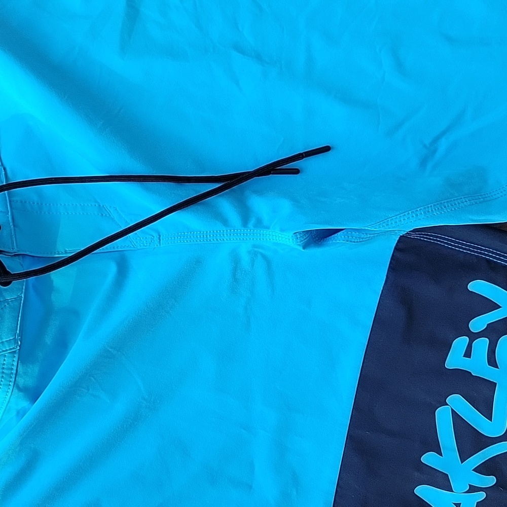 Men Oakley teal and black swim trunks